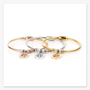 Detailed view of tree of life charm bracelets in gold, silver, and rose gold with magnetic clasps