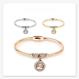 Macro display of Tree of Life bracelets in silver, gold, and rose gold with magnetic clasps