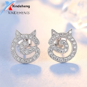 Macro shot of S925 sterling silver cat stud earrings with sparkling pave zircon stones