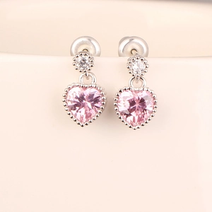 Macro shot of S925 sterling silver pink heart ruby earrings with cubic zirconia