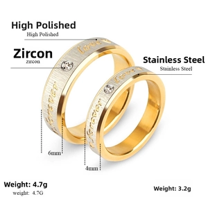 Detail of couple rings with Love Forever engraving and sparkling cubic zirconia