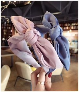 Detail of silk fabric knotted headbands in pink and grey-blue with smooth texture