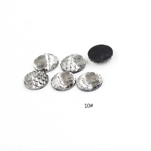 Detailed view of silver fish scale resin gems with glossy finish and black flat back for DIY