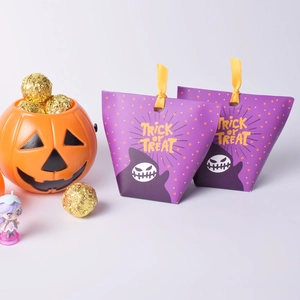 Halloween gift bag in purple with ghost patterns and yellow Trick or Treat text