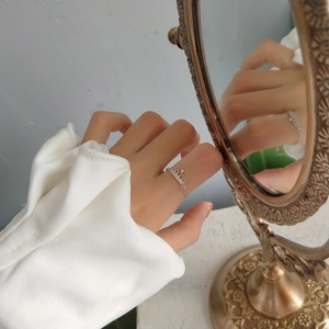 Detail of 925 silver tiara crown ring with zircons and chain band on model hand