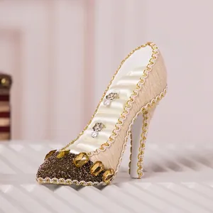 Elegant high-heel shaped jewelry holder stand with cream fabric and gold trim detail