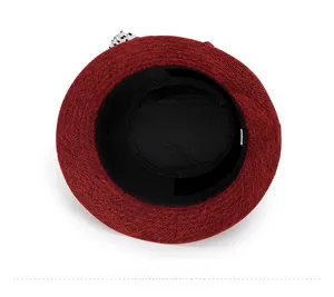 Detail view of the linen sun hat interior lining with black tape and polka dot ribbon