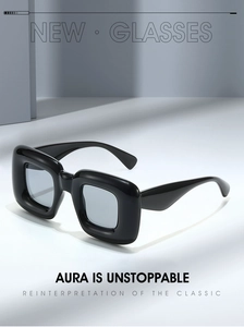 Macro shot of black Y2K square sunglasses with thick frames and glossy finish
