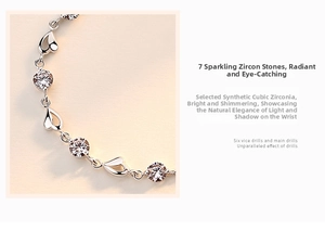 Detailed macro view of 925 sterling silver heart-shaped bracelet with cubic zirconia
