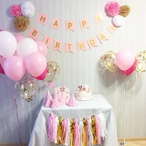 Pink and gold Happy Birthday banner with paper honeycombs and party tassels