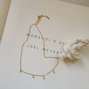 Minimalist 925 sterling silver gold beaded necklace with five small beads on a fine chain