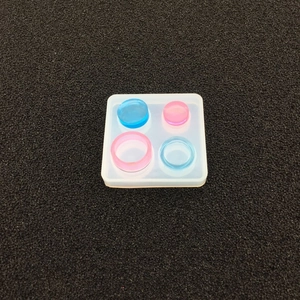 Square silicone mold for DIY resin pendants featuring colorful round cured pieces
