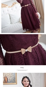 Detail of burgundy lace dress featuring champagne gold bow belt with rhinestone embellishment