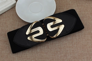 Detail of wide black elastic belt featuring a wavy golden alloy buckle and faux leather trim