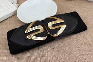 Detail of black elastic wide belt with golden streamline buckle on woven texture