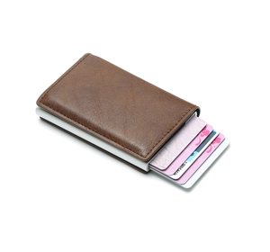 Detail of brown leather RFID blocking wallet showing the automatic pop-up card mechanism