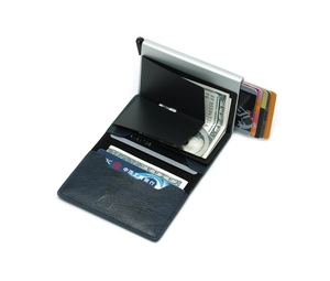Detail view of the silver aluminum card holder with dark blue textured leather wallet fold