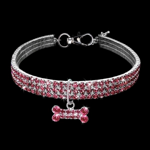 Detailed view of a pink rhinestone pet collar with a sparkling bone-shaped pendant
