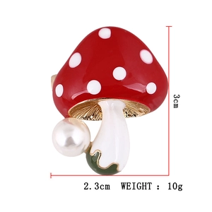 Detailed view of mushroom brooch with red enamel cap and pearl showing 3cm size dimensions