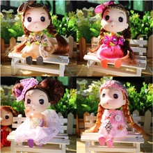 Detail of four colorful mini cartoon dolls in a miniature garden with white benches