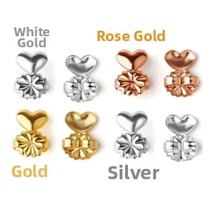 Macro view of heart-shaped earring lifters in four metal finishes for ear support