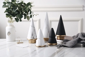 Macro detail of modern ceramic geometric figurines with marble texture and gold bases