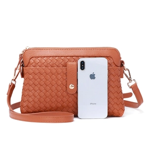 Brown woven leather crossbody bag with double pockets and adjustable shoulder strap