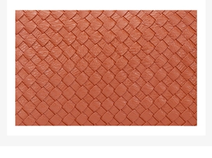 Detailed macro view of classic orange-brown woven leather texture for stylish handbags