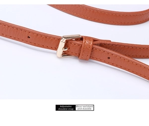 Detail of adjustable brown leather shoulder strap with polished gold-tone metal buckle