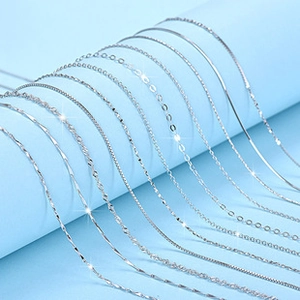 Macro view of various polished silver necklace chains including snake and link styles