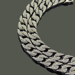 Close-up of a silver hip hop Cuban chain link bracelet with sparkling paved rhinestones