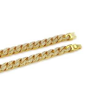 Mens hip hop gold plated Cuban link necklace with sparkling rhinestones on white background