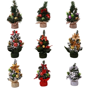 Mini artificial Christmas trees with ornaments and snowy needles for tabletop decor