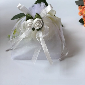 White organza drawstring gift bag with elegant satin roses and ribbon bow detail