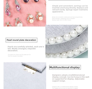 Detail of soft velvet jewelry display board with pearl accents and wall hanging hinges