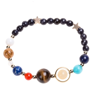 Close-up of Solar System bracelet featuring natural stones and a golden star charm