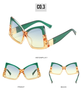 Macro detail of bow-shaped oversized sunglasses with green and amber tortoiseshell frames