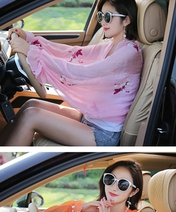 Close-up of pink floral embroidered sun protection shawl and orange chiffon arm sleeves