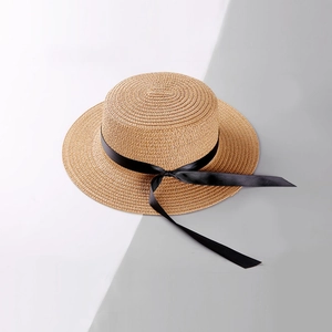 Flat top straw sun hat with black ribbon bow for outdoor beach and summer UV protection
