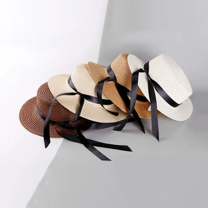 Straw sun hats with black ribbon bows in four colors including khaki and beige