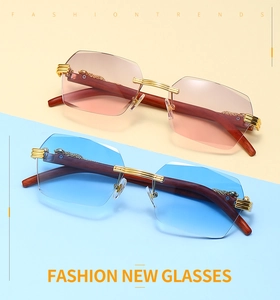 Detail of rimless gradient lenses with wooden temples and golden leopard head decor