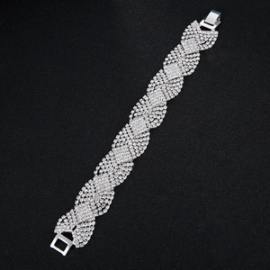 Detail of silver wide cuff bracelet with wavy rhinestone weaving and clasp closure