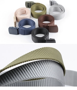 Macro detail of multicolored canvas nylon belts with durable plastic buckle and woven texture