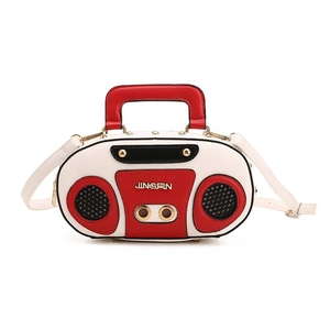 Detail view of a vintage radio style handbag with gold logo and contrast colors