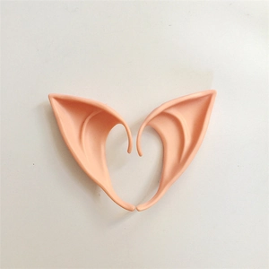 Macro shot of long latex elf ears for cosplay arranged in a heart shape on white background