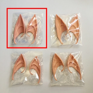Flat lay of four pairs of pointed elf ears in natural skin tone for cosplay parties