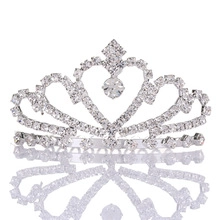 Detail of silver rhinestone crown showing intricate heart motifs and crystal patterns