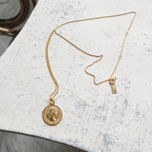Detail of 925 sterling silver gold coin necklace featuring Queen Elizabeth II carving