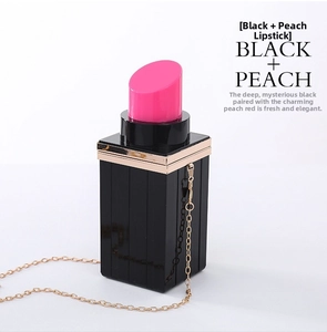 Detail view of lipstick shaped acrylic evening clutch with gold chain strap in black and peach