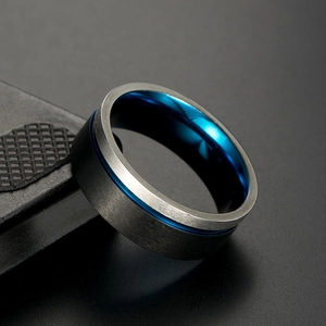 Macro side view of men's titanium steel ring with blue inner band and brushed silver finish